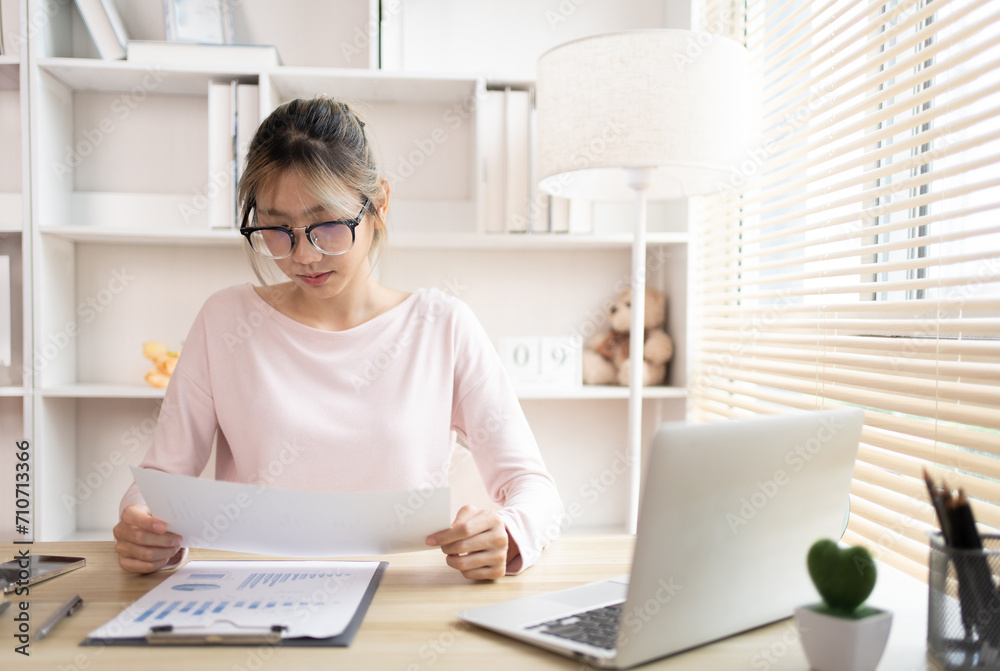 Thinking, Businesswoman analyzes data graphs and works intently in his personal office, Employees working in the office, Businesswoman at Desk.