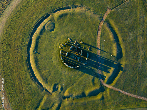 Aerial shot looking down on Stonehenge in low sun with long shadows
