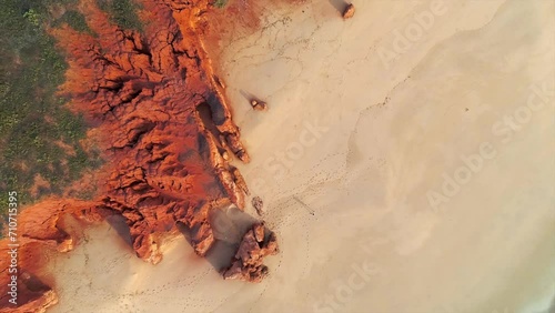 Aerial view of a long coastline with red rock formation and beach at James Price Point Broome, Western Australia, Australia. photo