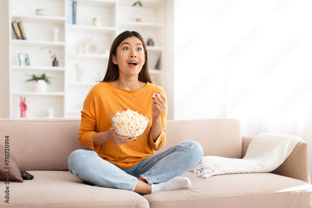 Amazed young asian woman watching movie or Tv program Amazed young asian woman watching movie or Tv program