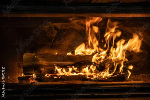 Detail of a home fireplace with burning wood