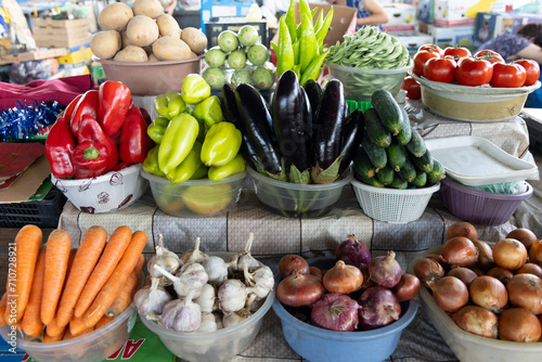 Closeup of market stall selling fresh assortment of vegetables from local ecological producers in bazaar photo