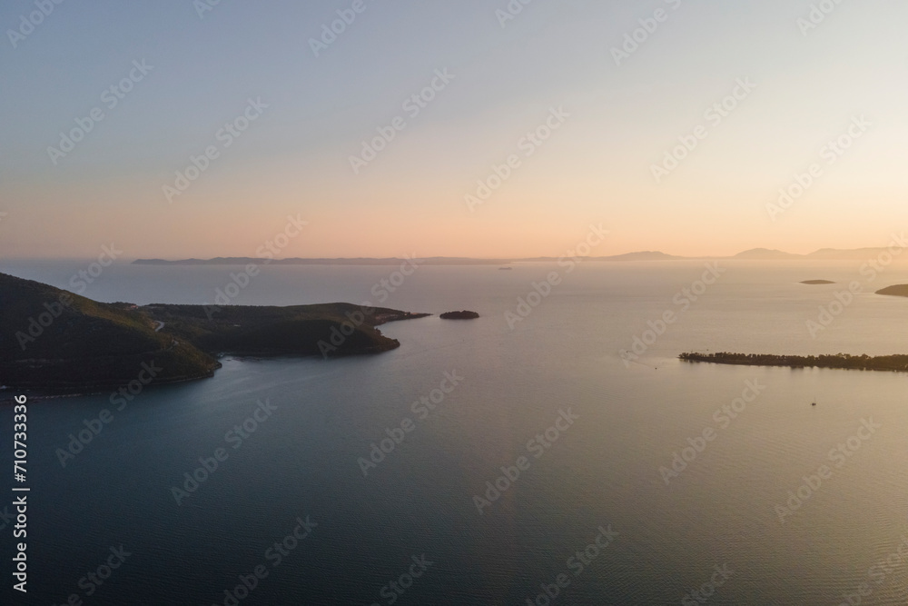 Aerial view of Igoumenitsa promontory at sunset along the Ionian Sea with Corfu Island in background, Epirus, Greece. Aerial view of Igoumenitsa promontory at sunset along the Ionian Sea with Corfu Island in background, Epirus, Greece.