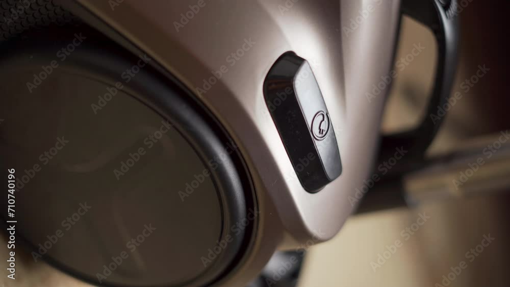 Woman turn on vacuum cleaner, close-up. Modern smart device cleaning floor and carpet. Lady using wireless technology. Woman turn on vacuum cleaner, close-up. Modern smart device cleaning floor and carpet. Lady using wireless technology.