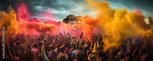 Crowd throwing bright colored powder paint in the air at Holi Festival Dahan photo