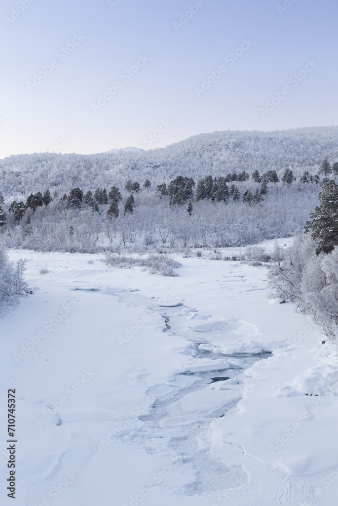 Frozen river in Abisko Nationalpark in winter scenery. Sweden, Arctic Circle, Swedish Lapland Frozen river in Abisko Nationalpark in winter scenery. Sweden, Arctic Circle, Swedish Lapland