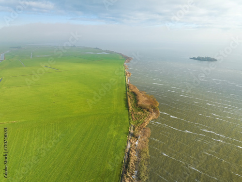 Aerial view of IJsselmeer coastline with small island Steile Bank, Huitebuersterbutenpolder, Nijemirdum, Gaasterland, Friesland, Netherlands. photo