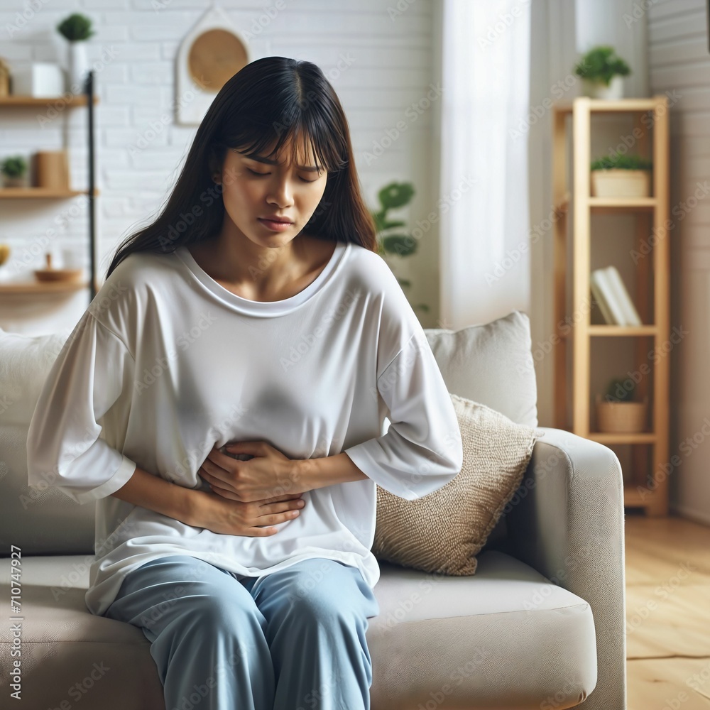 Sick woman suffering from stomach pain at home. Woman holding hand on painful stomach. Woman in pain. Medical concept. Generative AI. Sick woman suffering from stomach pain at home. Woman holding hand on painful stomach. Woman in pain. Medical concept. Generative AI.