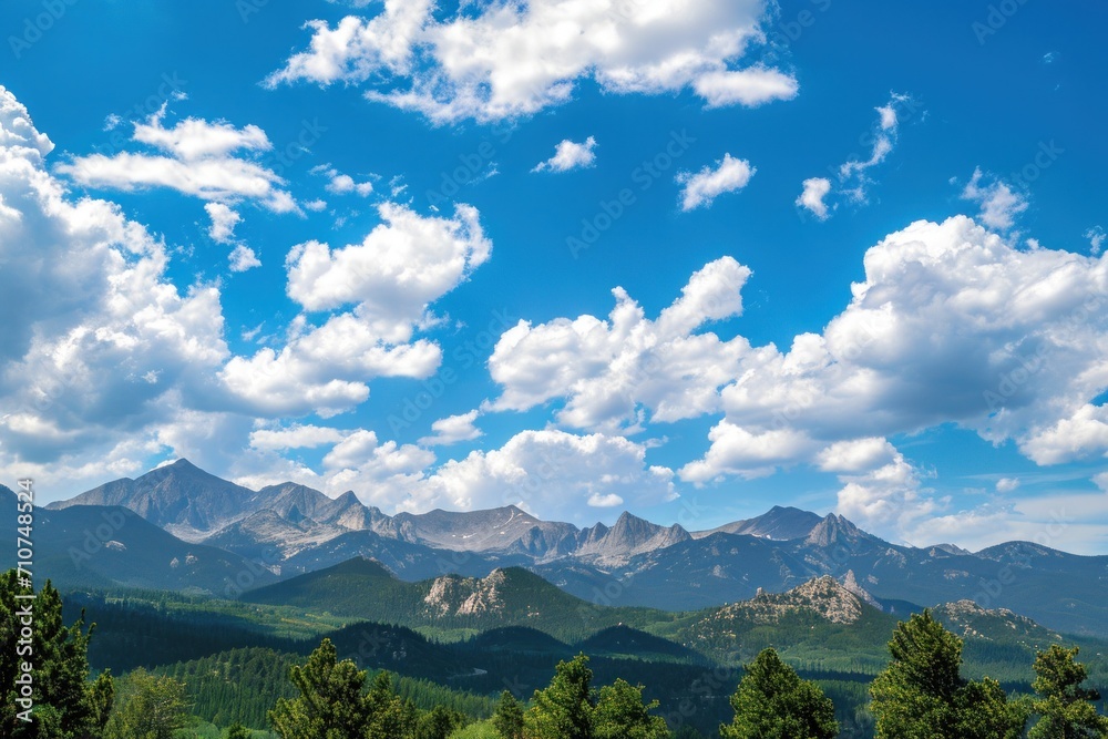 A panoramic view of towering mountains against a brilliant blue sky epitomizes summer beauty A panoramic view of towering mountains against a brilliant blue sky epitomizes summer beauty