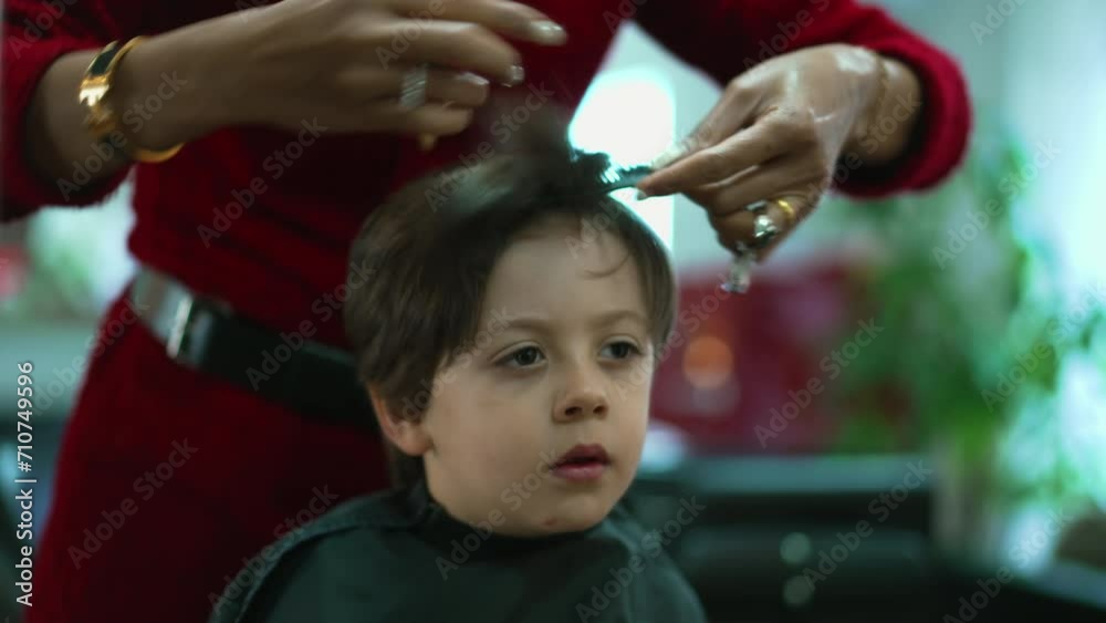 Little Boy Getting a Haircut at Salon, Professional Hairstylist Combing and cutting child's Hair Little Boy Getting a Haircut at Salon, Professional Hairstylist Combing and cutting child's Hair