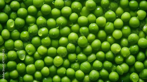  a close up view of a bunch of green peas with drops of water on the top of the green peas.