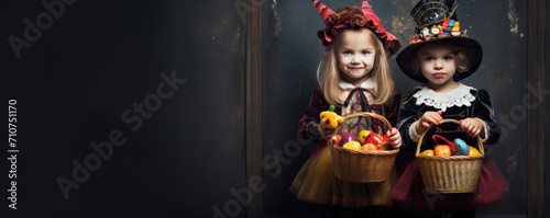 Children in halloween costumes with candy buckets. Free space for text. Halloween concept. Halloween backgorund