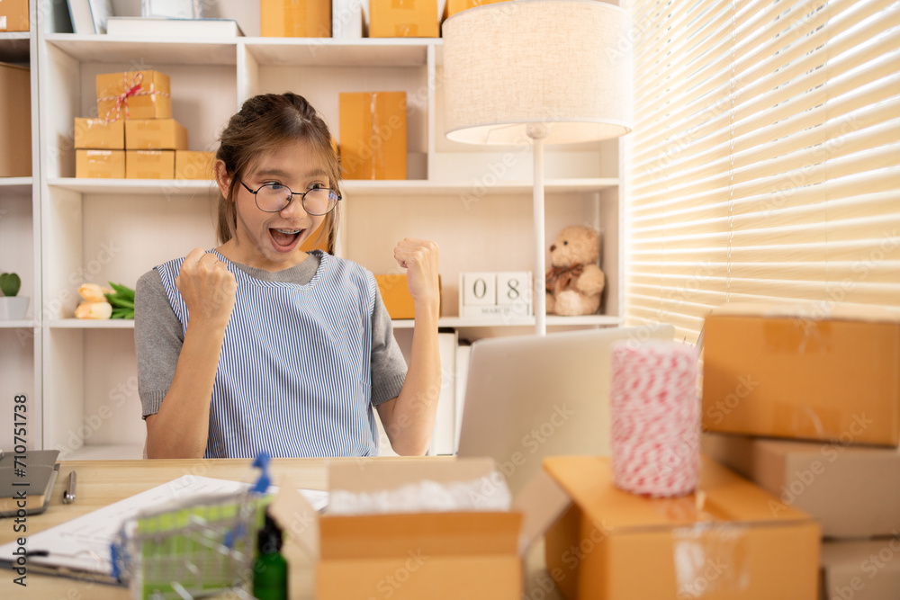 Sell products online, Happy Woman Celebrating Order from Internet Customer: New Business Style, Online Selling, Young Entrepreneur's Success: Work-from-Home SME Owner Thrives in Online Sales. Sell products online, Happy Woman Celebrating Order from Internet Customer: New Business Style, Online Selling, Young Entrepreneur's Success: Work-from-Home SME Owner Thrives in Online Sales.