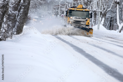 Shoveling snow from the road and blowing snow, snowy roads on a winter day, close-up © STOATPHOTO