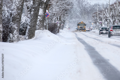 A snowplow is coming, cleaning the snow after a heavy snowfall in a harsh winter