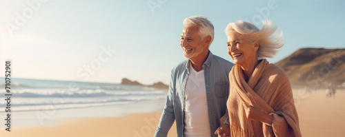 Happy senior couple on the beach, enjoying their time together on the vacation photo