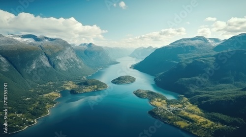  an aerial view of a body of water in the middle of a mountainous area with trees and mountains in the background.