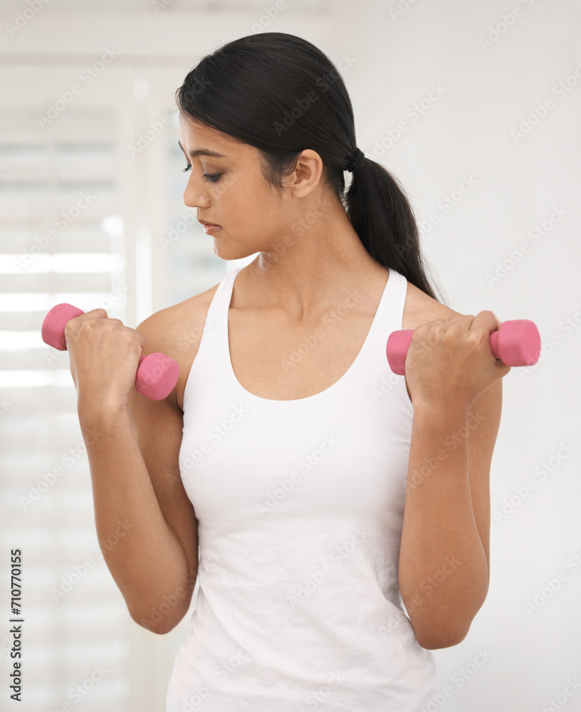 Woman, dumbbell and home fitness with workout, wellness and exercise in living room with weights. Health, Indian female person and house gym with training and healthy routine for athlete in a house Woman, dumbbell and home fitness with workout, wellness and exercise in living room with weights. Health, Indian female person and house gym with training and healthy routine for athlete in a house