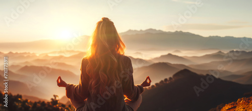 Banner Woman practicing yoga and meditation on mountain at sunset photo