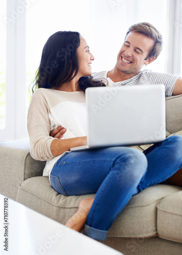 Couple, laptop and relax together on sofa with love, living room and wellness in marriage for bonding. Woman, man and smile for relationship care on subscription, weekend and streaming video in home