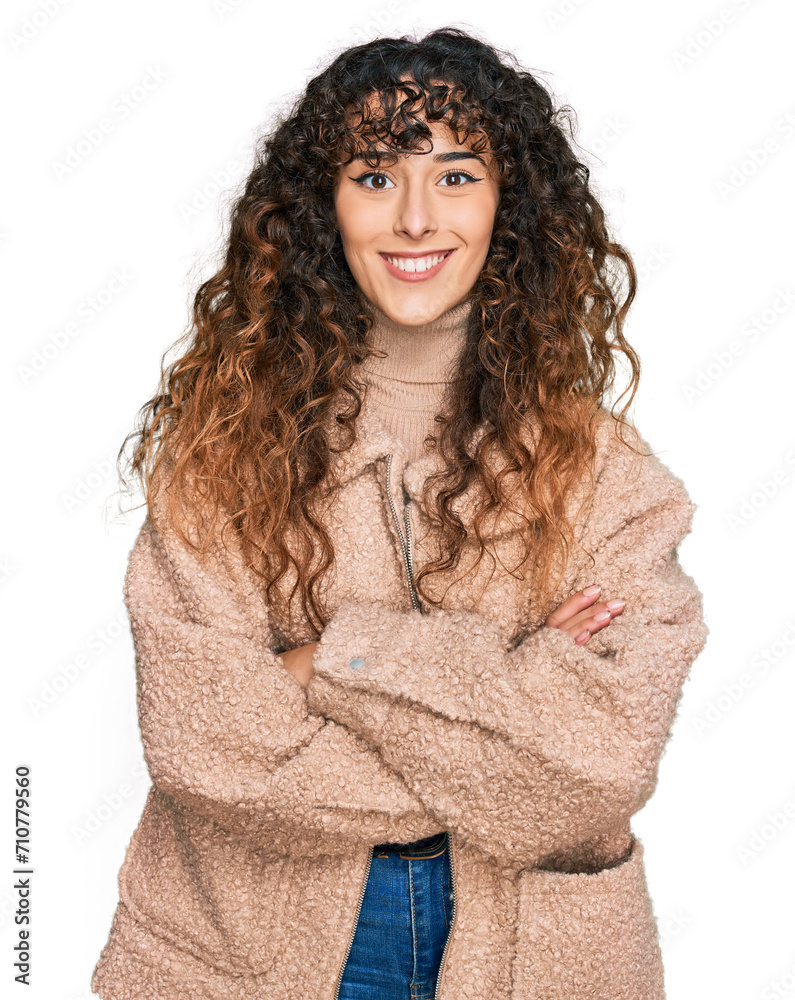 Young hispanic girl wearing winter clothes happy face smiling with crossed arms looking at the camera. positive person. Young hispanic girl wearing winter clothes happy face smiling with crossed arms looking at the camera. positive person.
