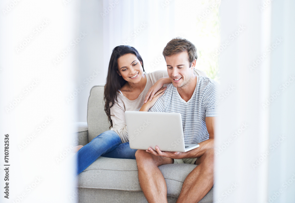Couple, laptop and watch movies on couch with love, living room and wellness in marriage for bonding. Woman, man and smile for relationship care on subscription, weekend and streaming video in home Couple, laptop and watch movies on couch with love, living room and wellness in marriage for bonding. Woman, man and smile for relationship care on subscription, weekend and streaming video in home