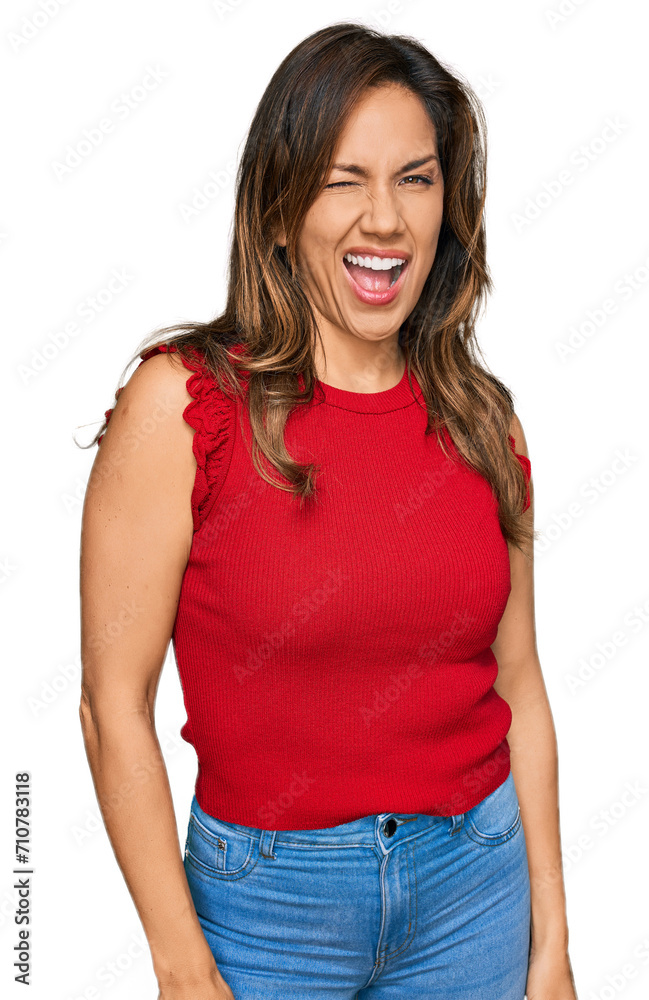 Obraz premium Young hispanic woman wearing casual clothes winking looking at the camera with sexy expression, cheerful and happy face.