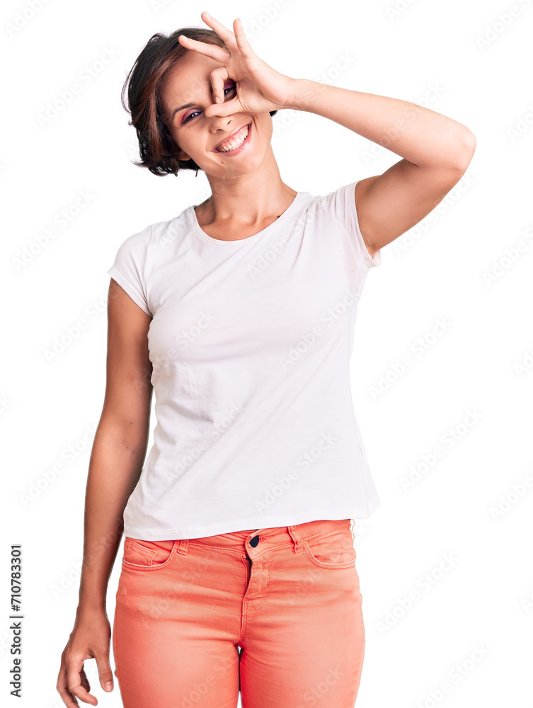 Beautiful young woman with short hair wearing casual clothes smiling happy doing ok sign with hand on eye looking through fingers Beautiful young woman with short hair wearing casual clothes smiling happy doing ok sign with hand on eye looking through fingers