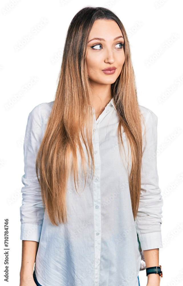 Beautiful caucasian woman wearing casual white shirt smiling looking to the side and staring away thinking. Beautiful caucasian woman wearing casual white shirt smiling looking to the side and staring away thinking.