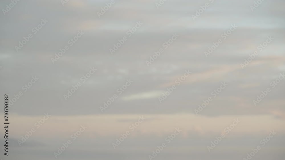 A young woman walks at sunset along a mountain road, with the city and the sea visible far below. A young woman walks at sunset along a mountain road, with the city and the sea visible far below.