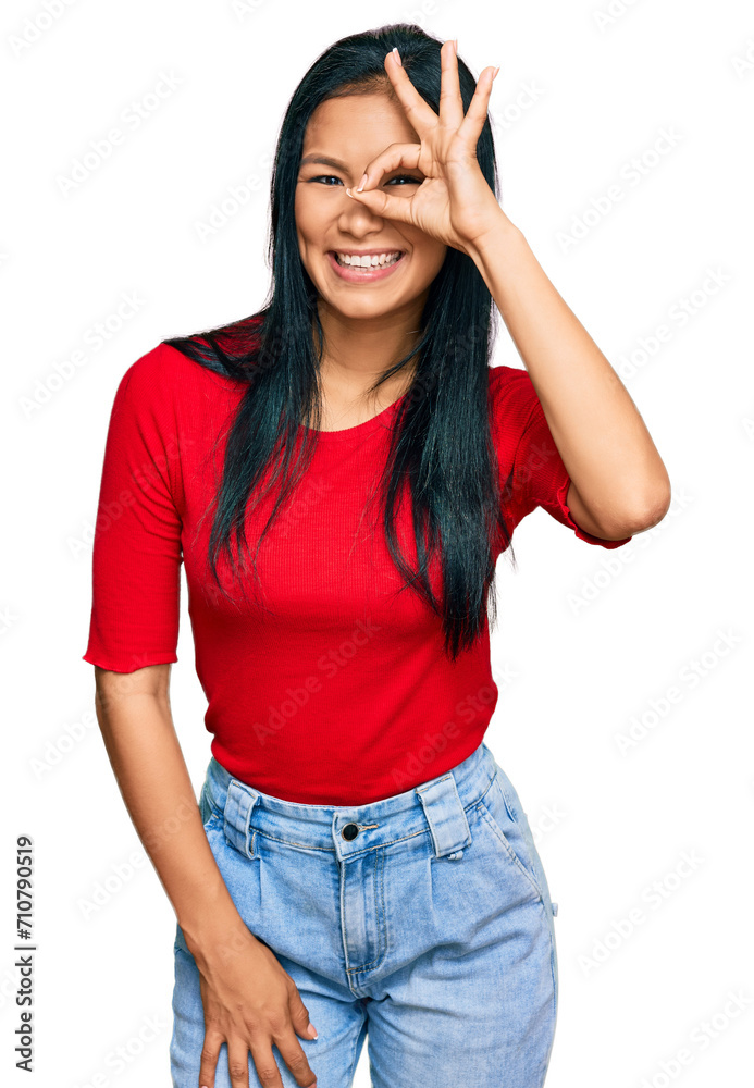 Beautiful hispanic woman wearing casual clothes doing ok gesture with hand smiling, eye looking through fingers with happy face. Beautiful hispanic woman wearing casual clothes doing ok gesture with hand smiling, eye looking through fingers with happy face.