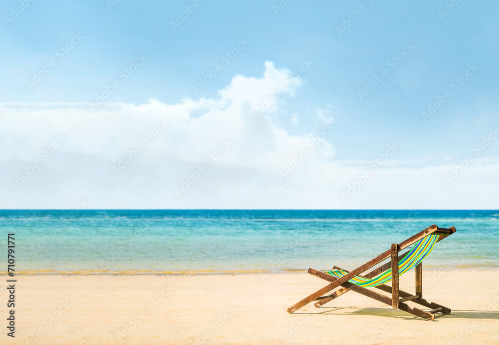 Lounge chairs on a tropical beach at summer Lounge chairs on a tropical beach at summer