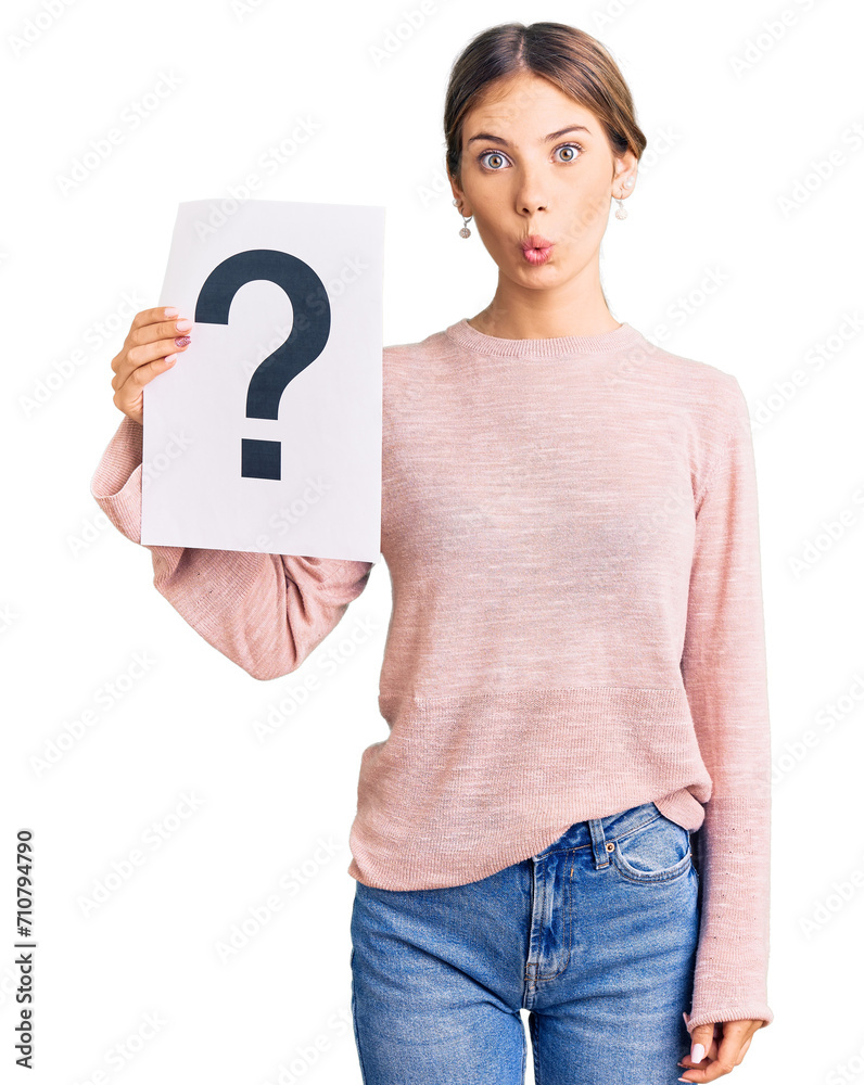 Beautiful caucasian woman with blonde hair holding question mark scared and amazed with open mouth for surprise, disbelief face Beautiful caucasian woman with blonde hair holding question mark scared and amazed with open mouth for surprise, disbelief face