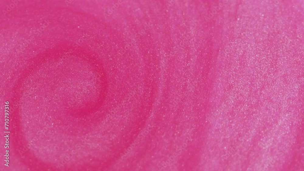 Abstract background. Shimmering paint motion. Glitter wave. Shiny glamourous pink grain texture substance twirl spreading in fantasy trendy art.