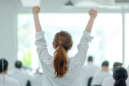 A portrait woman Raise hands up in joy with white shirt in white tone office 