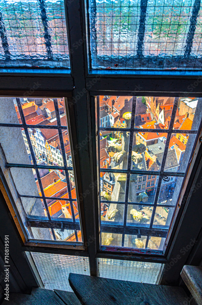 Top view from the window of Belfry bell tower of Bruges historical city centre with old buildings red tiled roofs, Brugge old town quarter district, West Flanders province, Flemish region, Belgium Top view from the window of Belfry bell tower of Bruges historical city centre with old buildings red tiled roofs, Brugge old town quarter district, West Flanders province, Flemish region, Belgium