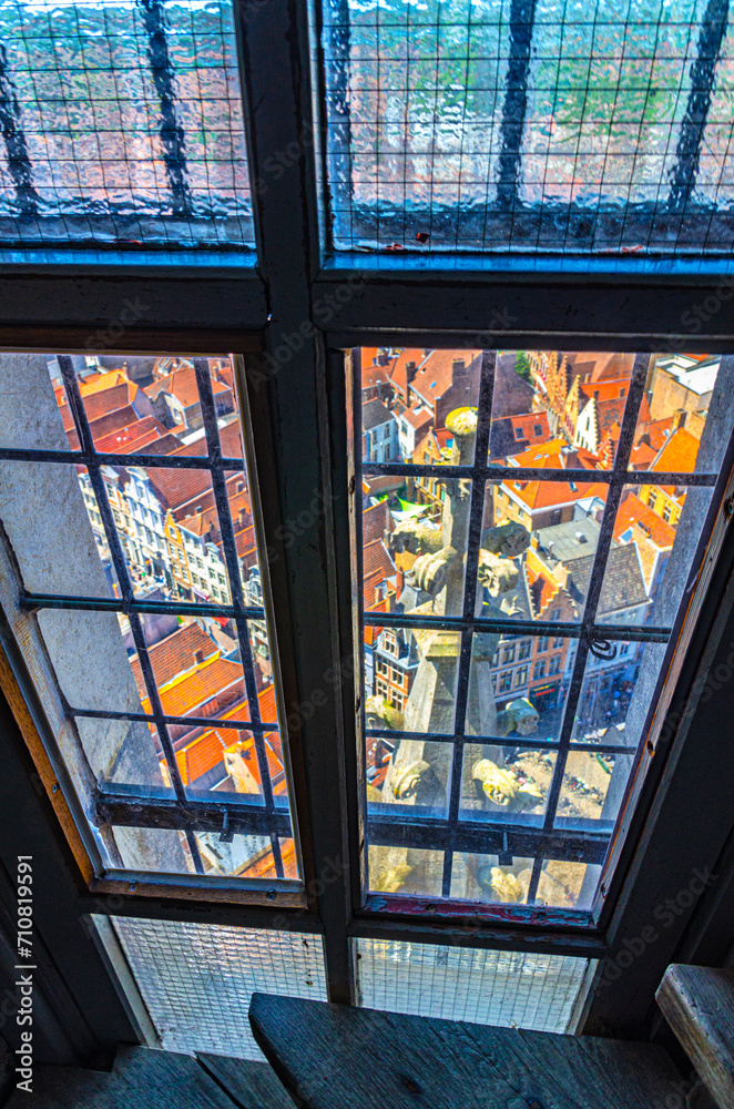 Top view from the window of Belfry bell tower of Bruges historical city centre with old buildings red tiled roofs, Brugge old town quarter district, West Flanders province, Flemish region, Belgium