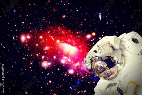 Astronaut surfing dark space. Planets, stars. Space scene. The elements of this image furnished by NASA.