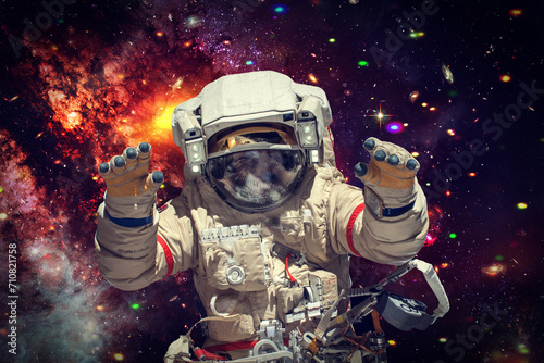 Astronaut surfing dark space. Planets, stars. Space scene. The elements of this image furnished by NASA.