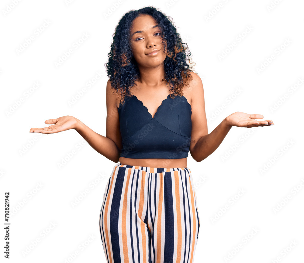 Young african american woman wearing casual clothes clueless and confused expression with arms and hands raised. doubt concept. Young african american woman wearing casual clothes clueless and confused expression with arms and hands raised. doubt concept.