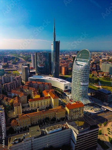 Aerial view of modern stylish cityscape of business skyscrapers. unicredit tower and UnipolSai, Microsoft Italia. Skyline. Drone. Sunny day and blue sky. Fashion city. Europe Italy Milan 01.2024 photo