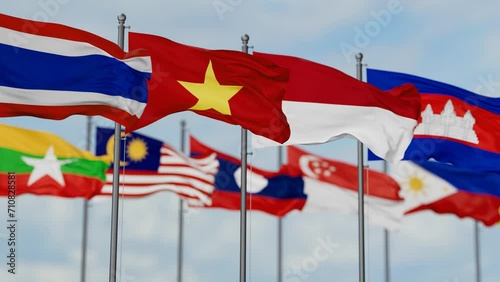 ASEAN or Association of Southeast Asian Nations flags waving together on cloudy sky, endless seamless loop photo