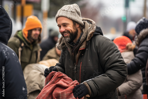 Volunteers distributing warm blankets and essentials to homeless individuals during the winter season, providing comfort and warmth.