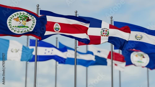 SICA Central American Integration System flags waving together on cloudy sky, endless seamless loop photo