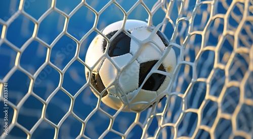 Soccer ball in the net after the goal - close-up of a classic black and white soccer ball