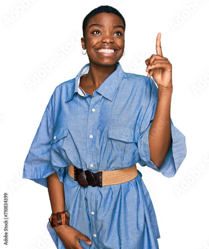 Young african american woman wearing casual clothes pointing finger up with successful idea. exited and happy. number one.