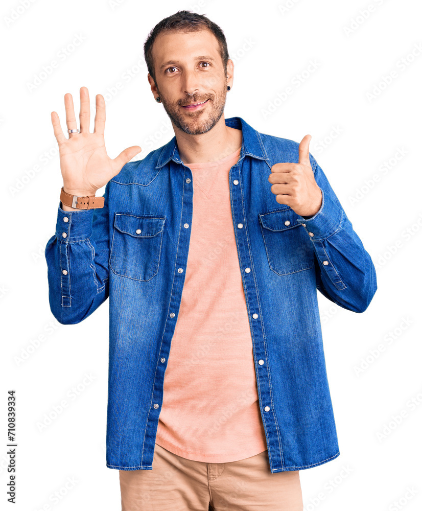 Young handsome man wearing casual clothes showing and pointing up with fingers number six while smiling confident and happy.