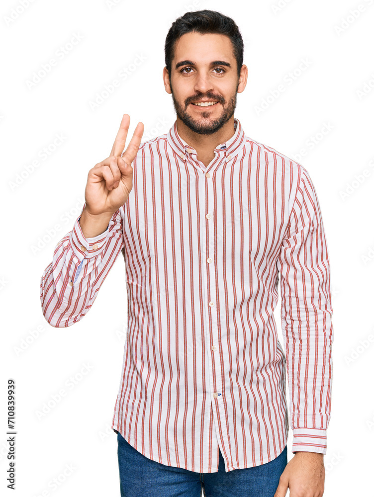 Young hispanic man wearing business shirt showing and pointing up with fingers number two while smiling confident and happy. Young hispanic man wearing business shirt showing and pointing up with fingers number two while smiling confident and happy.
