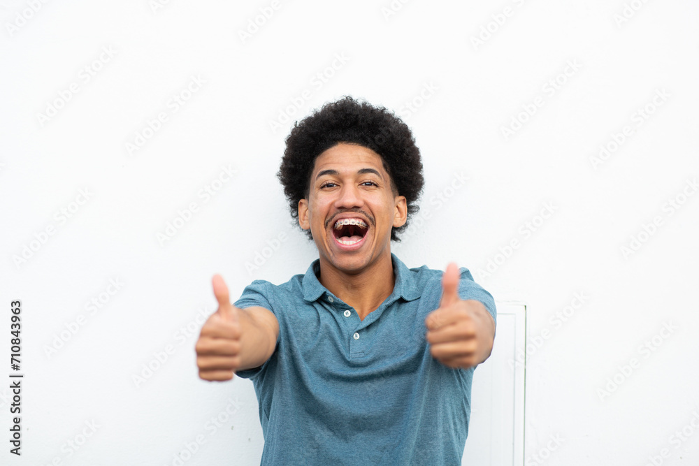 cheerful young man with thumbs up hand sign cheerful young man with thumbs up hand sign