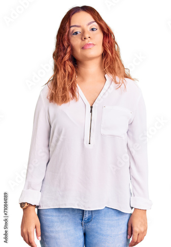 Young latin woman wearing casual clothes relaxed with serious expression on face. simple and natural looking at the camera.